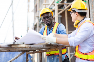 architect and construction worker working on site